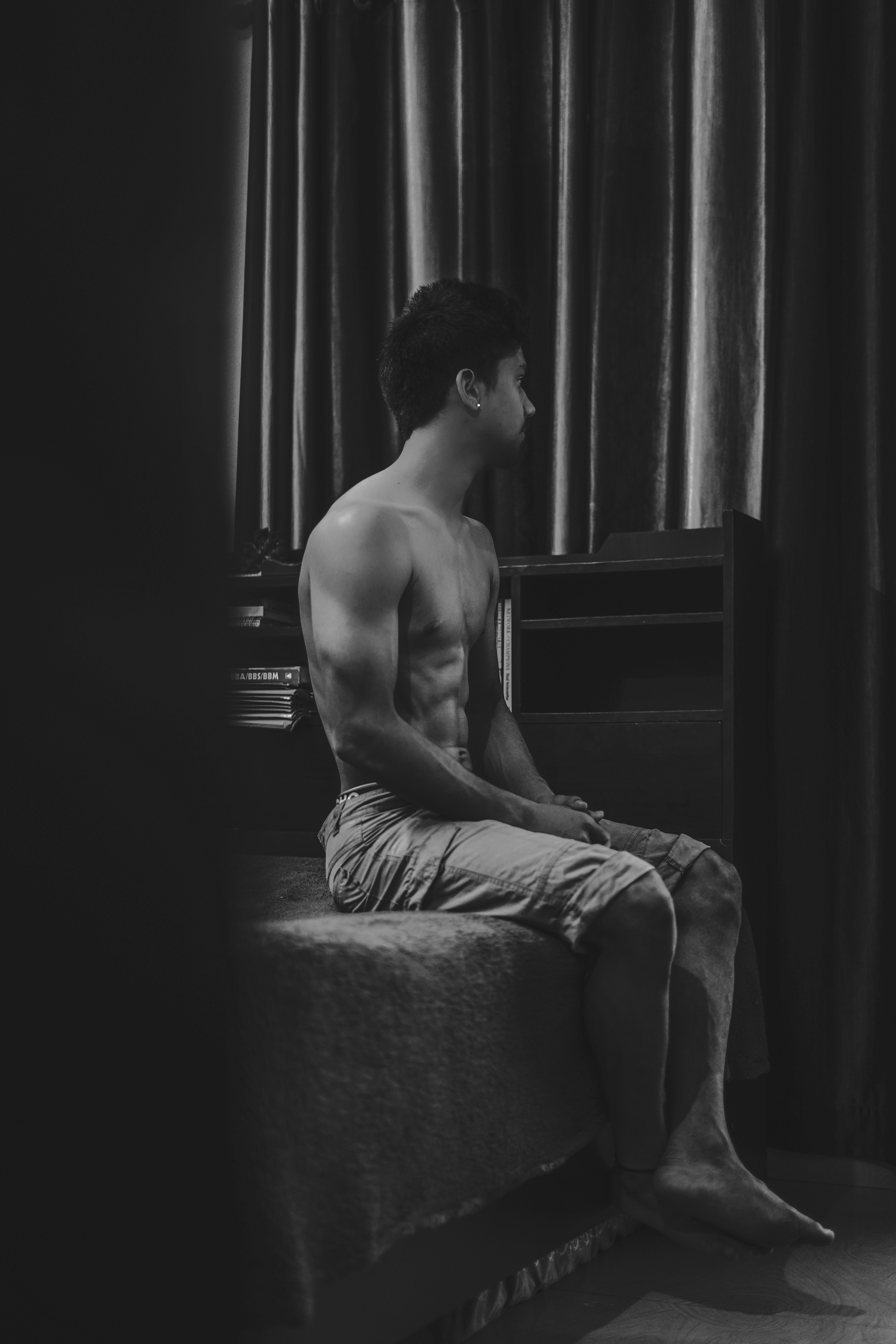 topless man sitting on chair